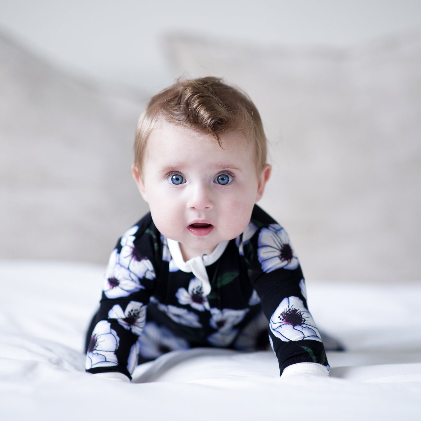 Violet Magnolia Bamboo Footed Sleeper - Peregrine Kidswear - Footed Sleepers - 0-3M shown on a baby on a bed